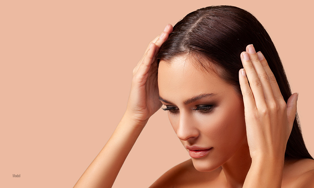 A woman worried about thinning hair