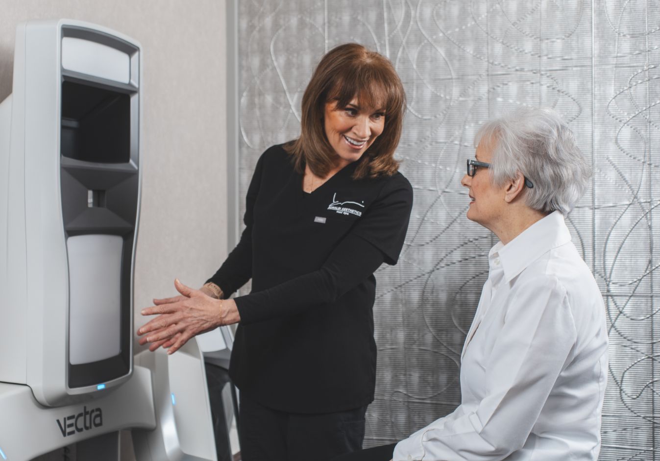 Patient with staff going over vectra 3D imaging